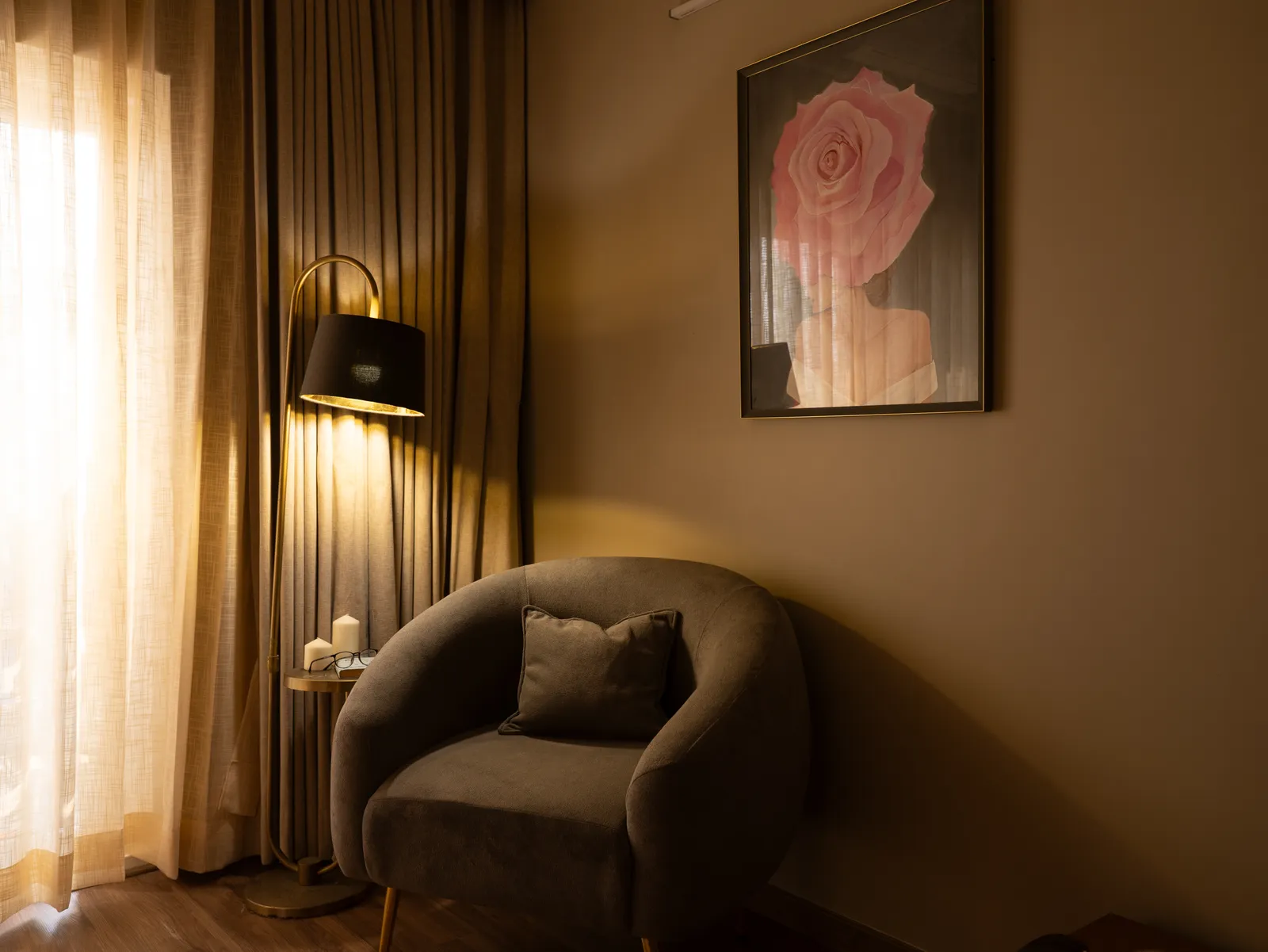 Reading corner with curved armchair and rose artwork — Amlan's Residence